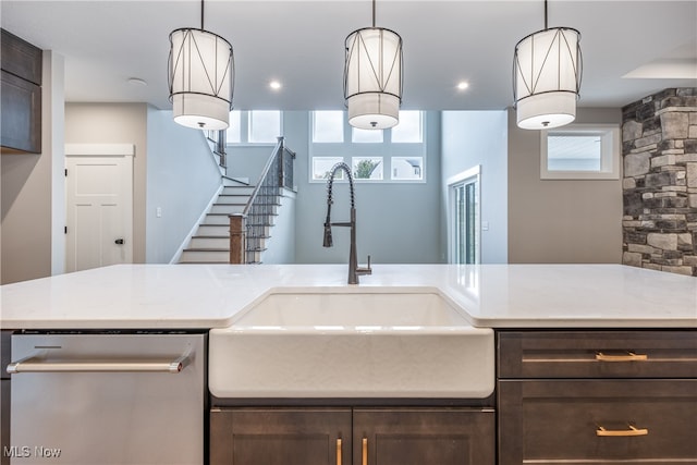 kitchen with dark brown cabinetry, hanging light fixtures, and a wealth of natural light