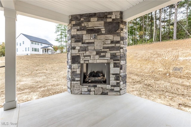 view of patio with an outdoor stone fireplace