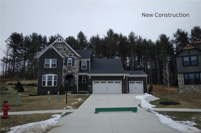 view of front of home featuring a garage and a front yard