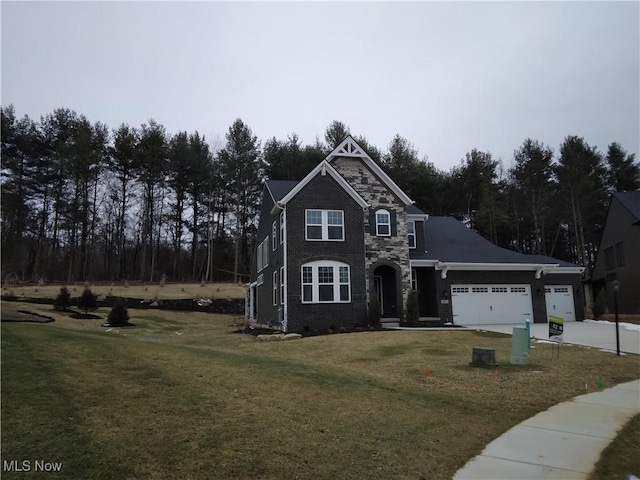 view of front of property featuring a garage and a front yard