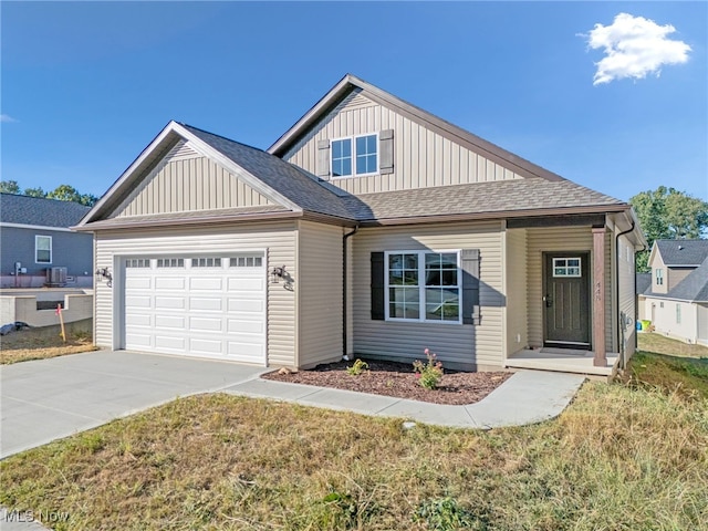 view of front of home featuring a front yard and a garage