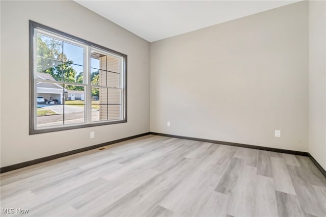 spare room with light hardwood / wood-style flooring