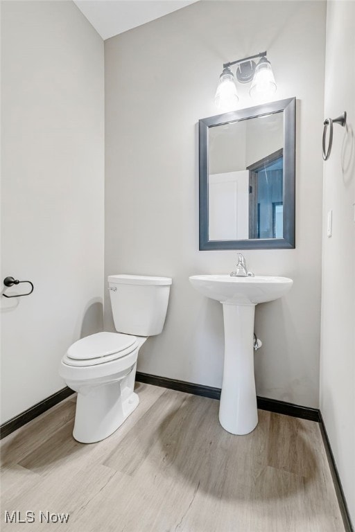 bathroom featuring toilet and hardwood / wood-style flooring