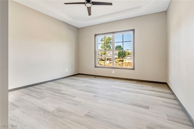 spare room featuring light wood-type flooring and ceiling fan