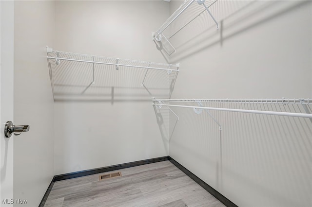 walk in closet featuring light hardwood / wood-style floors