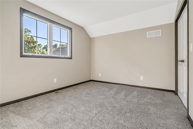 additional living space with vaulted ceiling and carpet floors