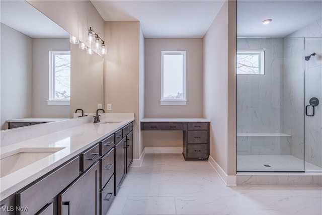 bathroom with marble finish floor, double vanity, a sink, and a healthy amount of sunlight