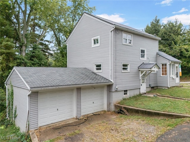 exterior space with a yard and a garage