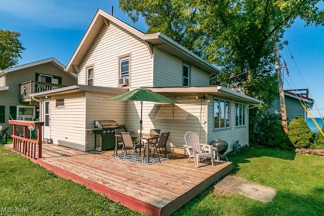 back of property with a lawn, cooling unit, and a deck