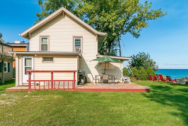 rear view of property featuring a lawn, cooling unit, a water view, and a patio