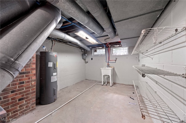 basement with electric water heater and sink