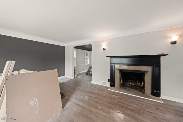 unfurnished living room featuring dark hardwood / wood-style floors