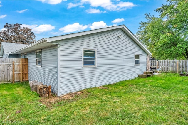 view of property exterior with a lawn