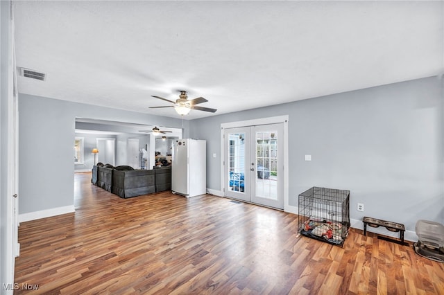 living room with french doors, hardwood / wood-style flooring, and ceiling fan