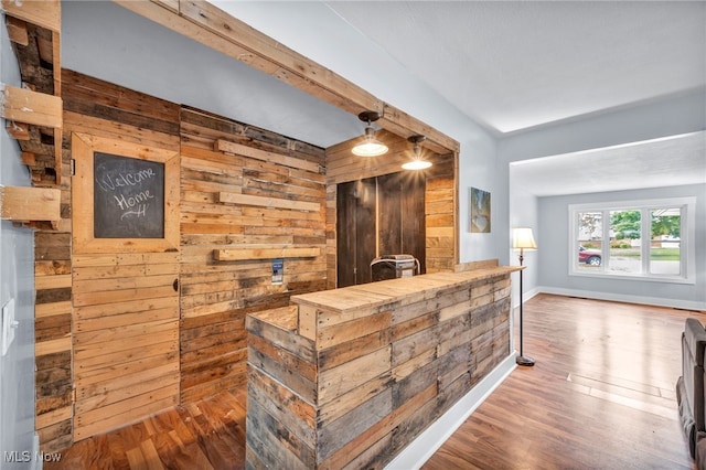 bar with wooden walls and hardwood / wood-style floors