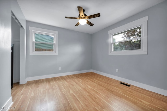 unfurnished room with light wood-type flooring and ceiling fan