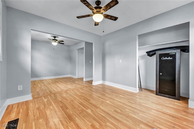 unfurnished living room featuring ceiling fan and light wood-type flooring