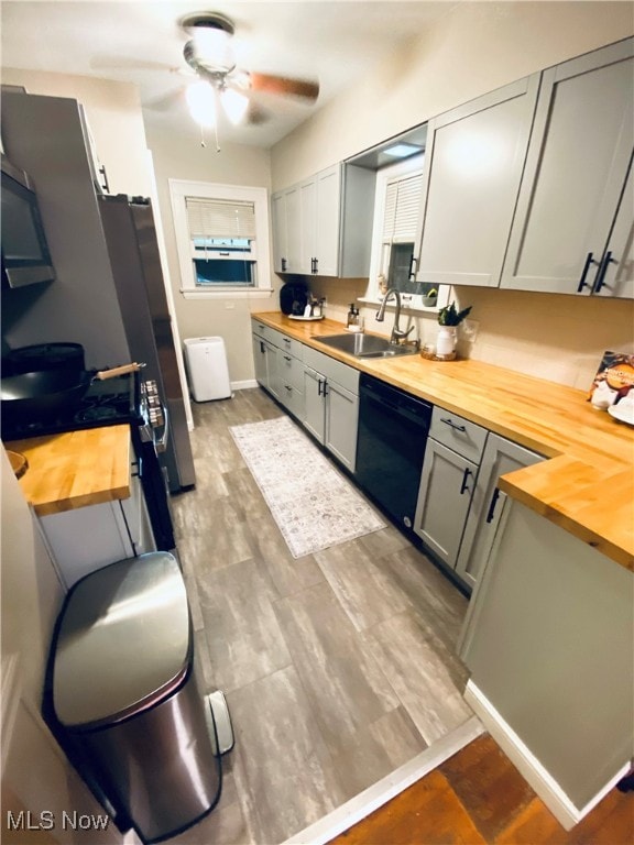 kitchen featuring appliances with stainless steel finishes, dark hardwood / wood-style floors, butcher block counters, and ceiling fan