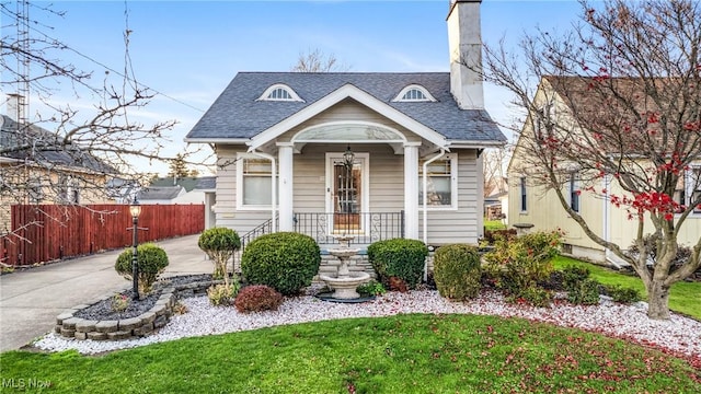 bungalow-style house with a front lawn