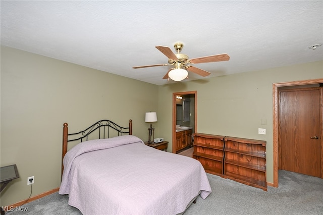 bedroom featuring ceiling fan, a textured ceiling, light carpet, and ensuite bathroom