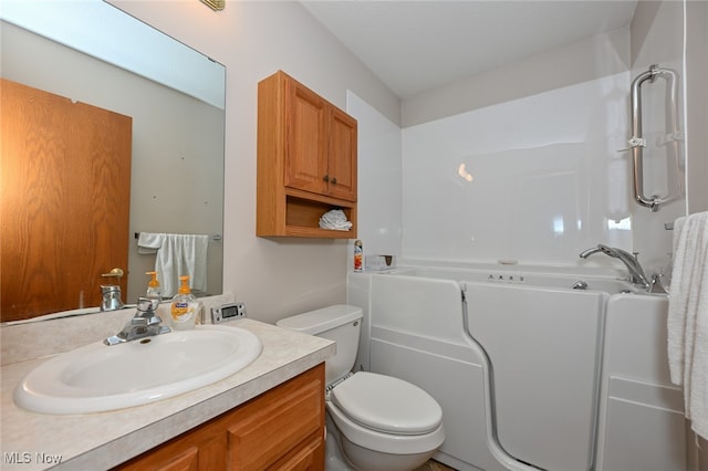 bathroom featuring a bathtub, vanity, and toilet