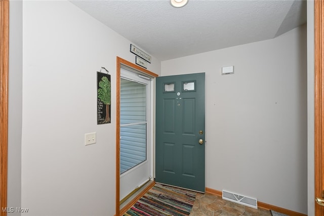 entrance foyer with a textured ceiling