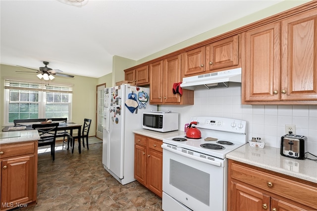 kitchen featuring white appliances, ceiling fan, and tasteful backsplash