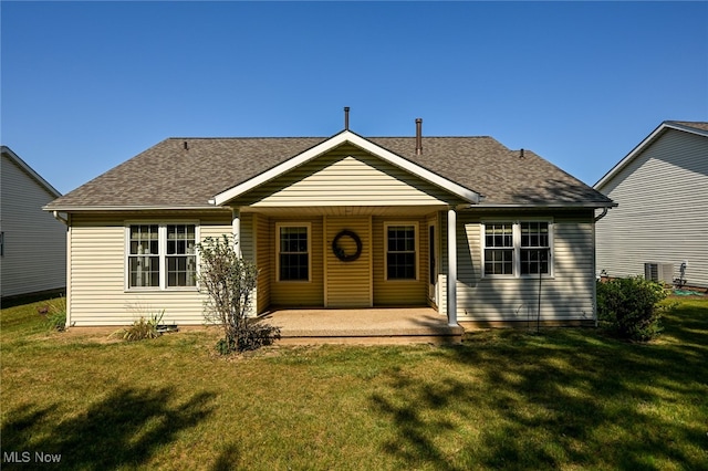 view of front of house with a patio and a front lawn