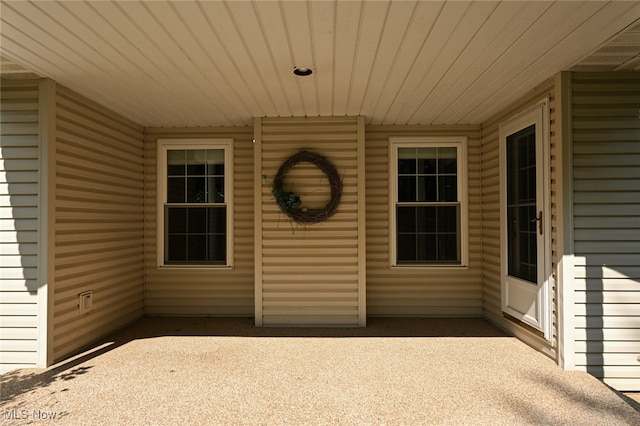 property entrance featuring a patio