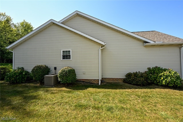 view of home's exterior featuring a lawn and central air condition unit