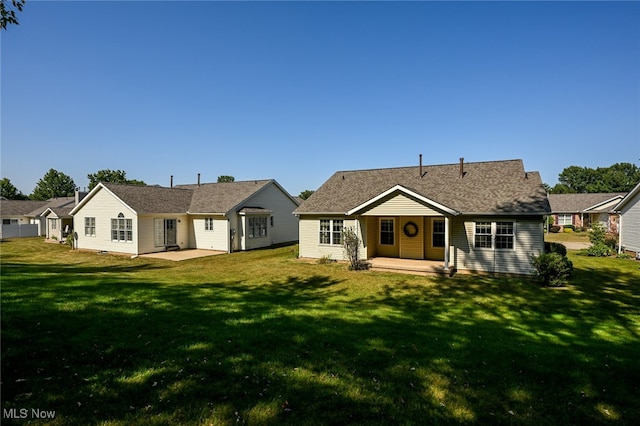 back of property featuring a patio area and a yard