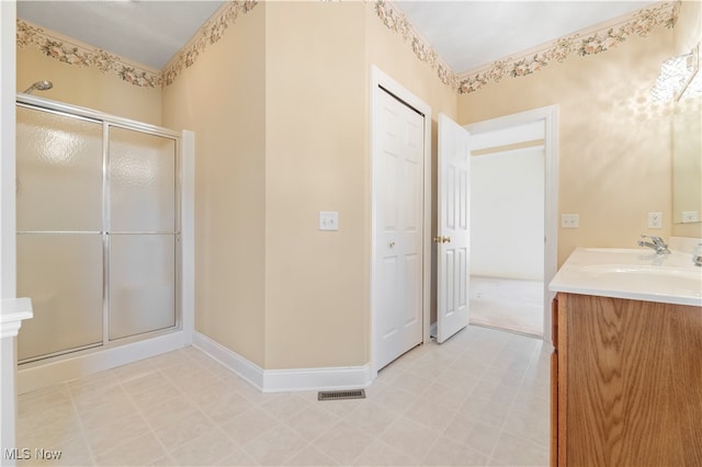 bathroom with vanity and a shower with shower door