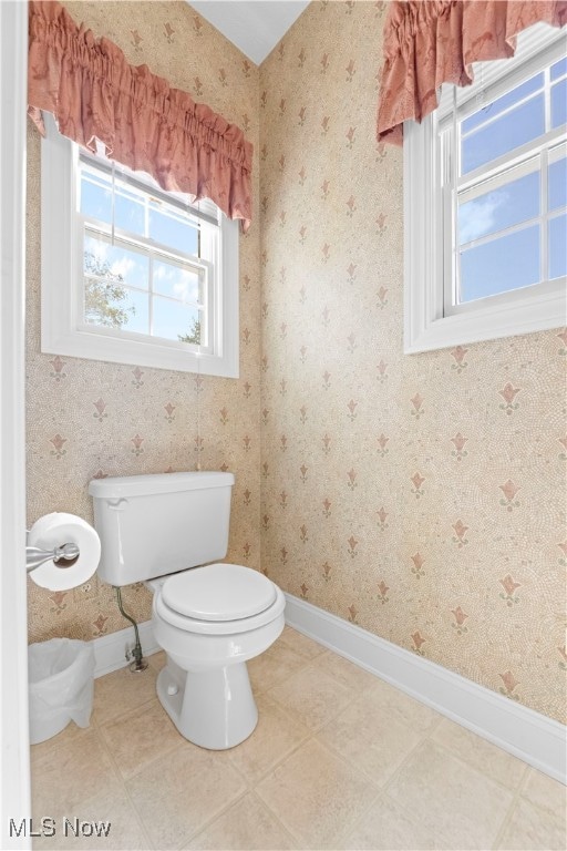 bathroom featuring plenty of natural light and toilet