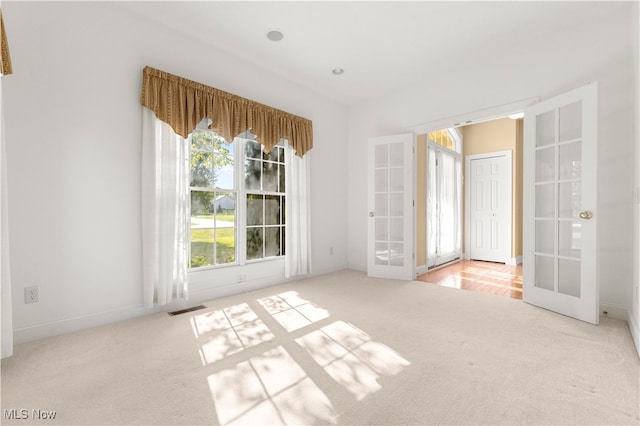 carpeted empty room with french doors