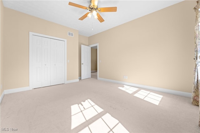 unfurnished bedroom with a closet, ceiling fan, and carpet floors