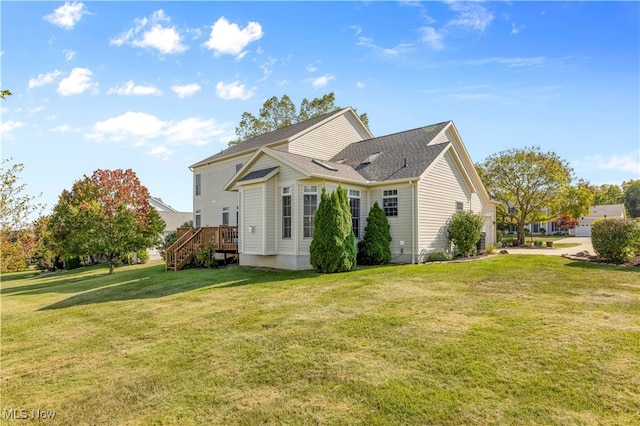 back of property featuring a yard