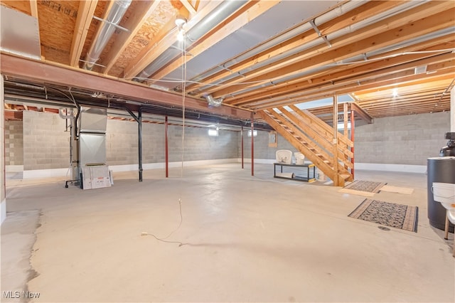 basement featuring water heater and heating unit