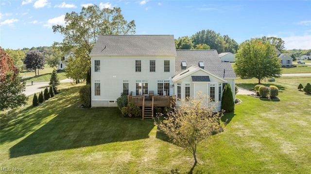 back of property featuring a wooden deck and a yard