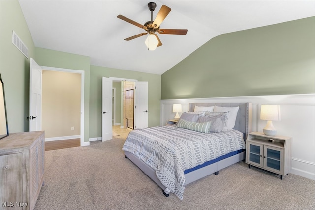 carpeted bedroom featuring vaulted ceiling and ceiling fan