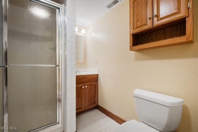 bathroom featuring toilet, vanity, and a shower with door