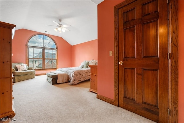 carpeted bedroom with vaulted ceiling and ceiling fan