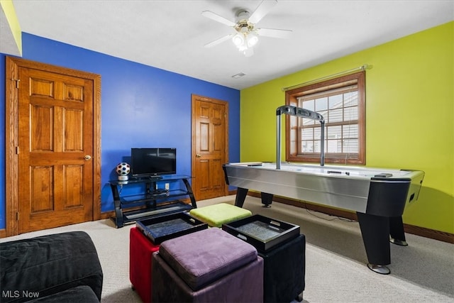 game room with ceiling fan and light colored carpet