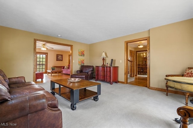 living room with light carpet and a chandelier