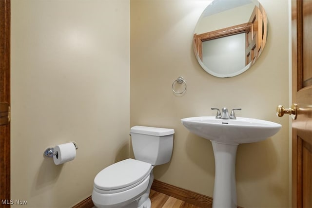 bathroom featuring toilet and hardwood / wood-style floors