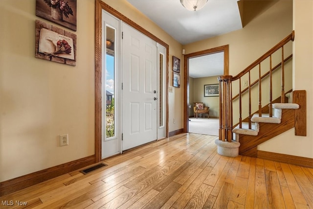 foyer entrance with light hardwood / wood-style flooring