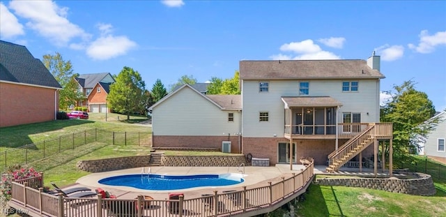 back of house with a sunroom, a swimming pool side deck, a yard, central AC unit, and a patio area