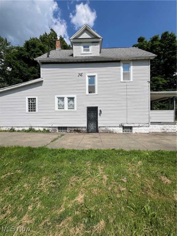 rear view of property with a lawn and a patio area