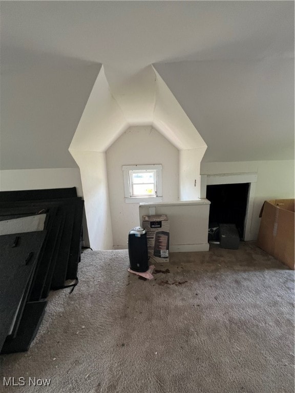 bonus room with carpet floors and vaulted ceiling