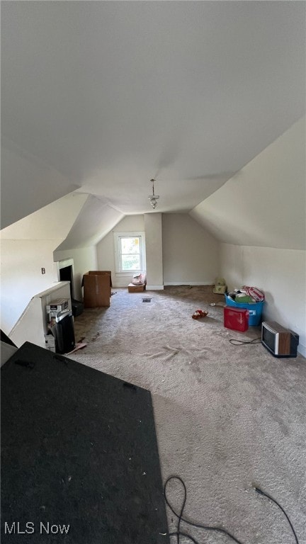 bonus room with carpet and vaulted ceiling