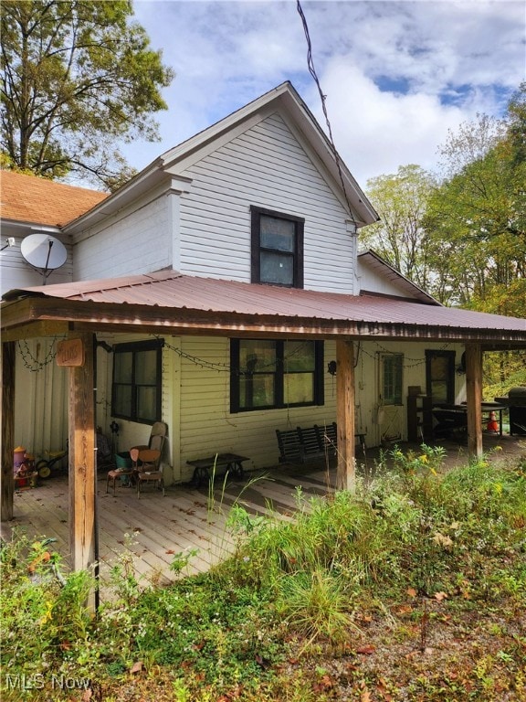 rear view of house with a wooden deck